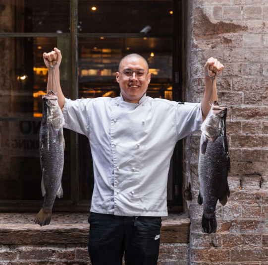 Chef with two Infinity Blue Barramundi