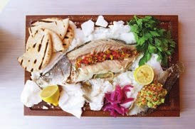 Whole Wyndham barramundi on a sharing board with salsa, lemon, pickled onion and flatbread