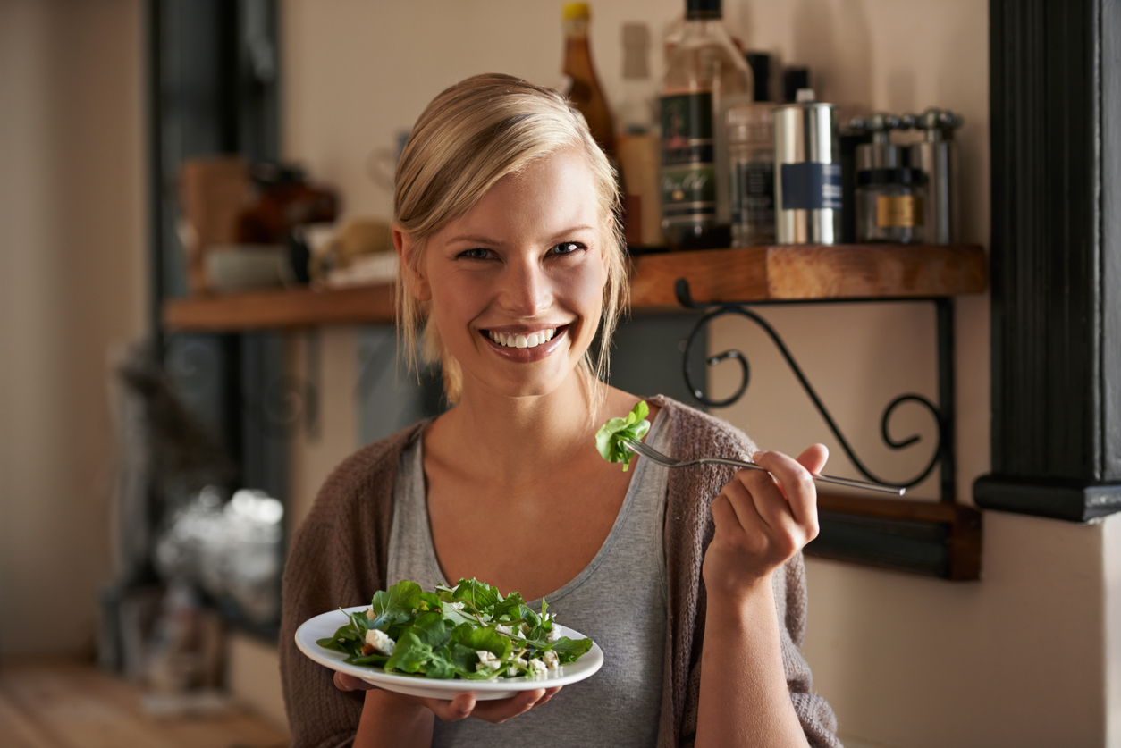 Woman eating barramundi salad