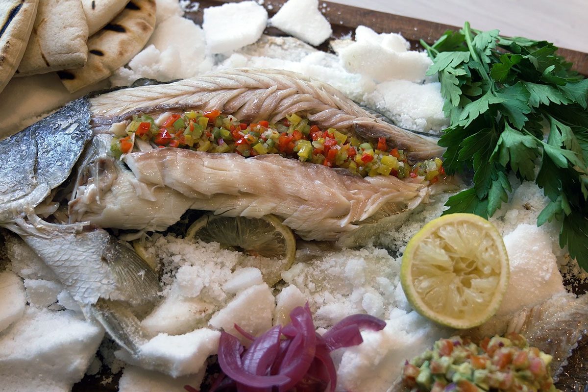 Salt baked barramundi dish